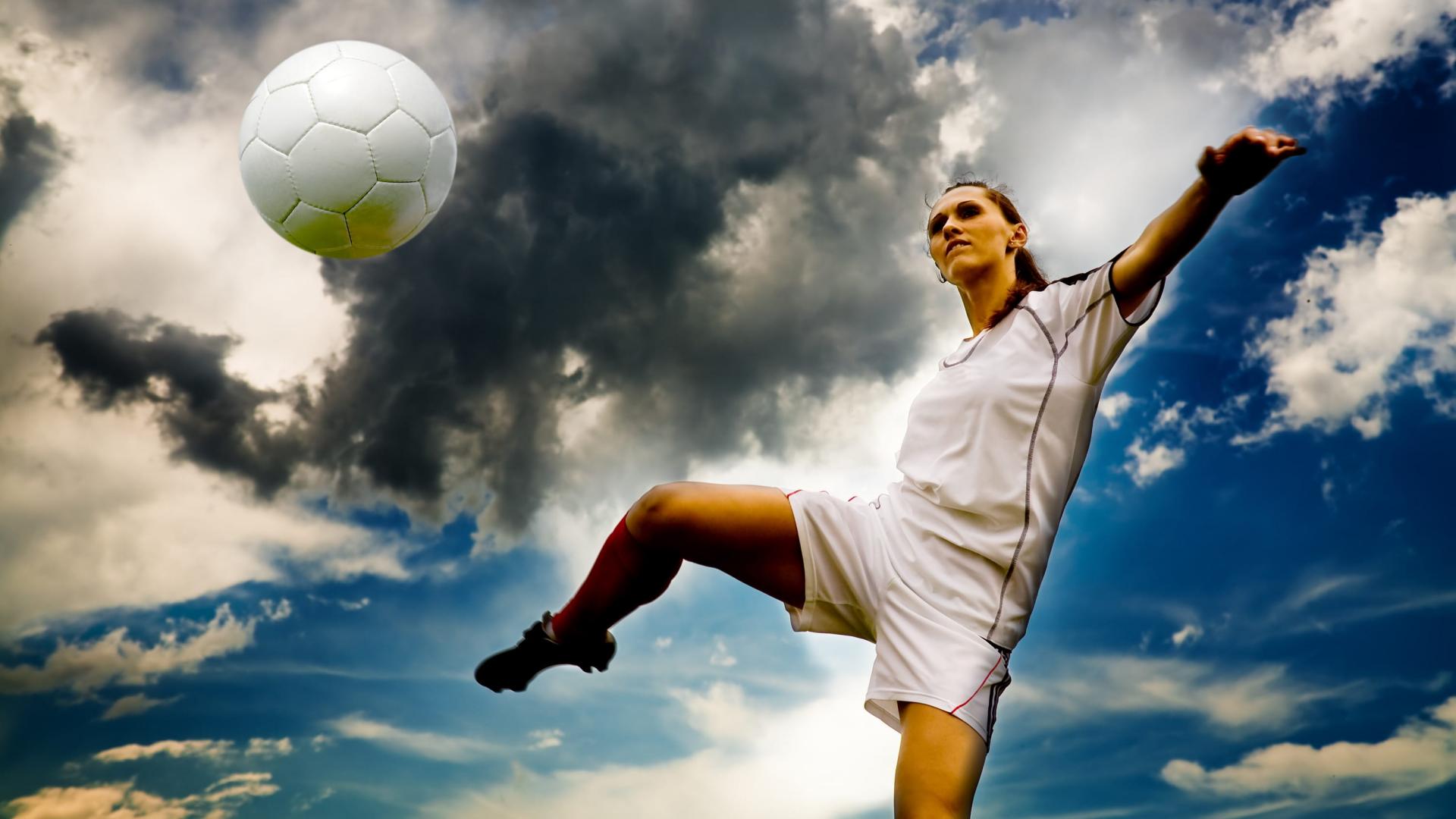 Female soccer player volleying a ball, showing great touch